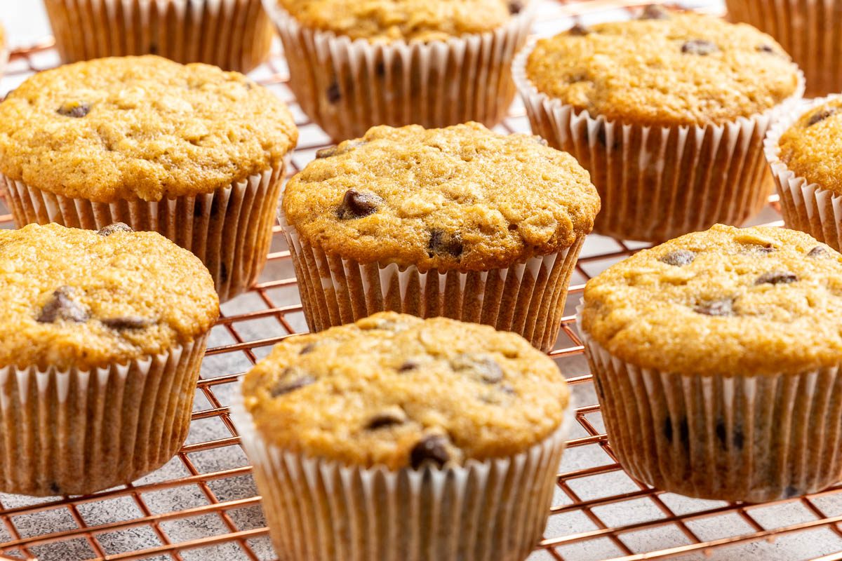 Taste of Home Oatmeal Chocolate Chip Muffins recipe photo of the finished recipe served on plates and a cooling rack.