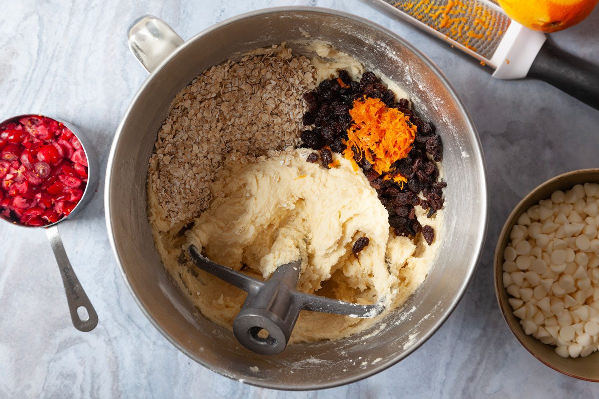 Step 1 of Taste of Home Oatmeal Cranberry Cookies is to cream the butter and sugar before adding the eggs and vanilla. Then adding the orange zest, raisins, oats, cranberries, baking chips