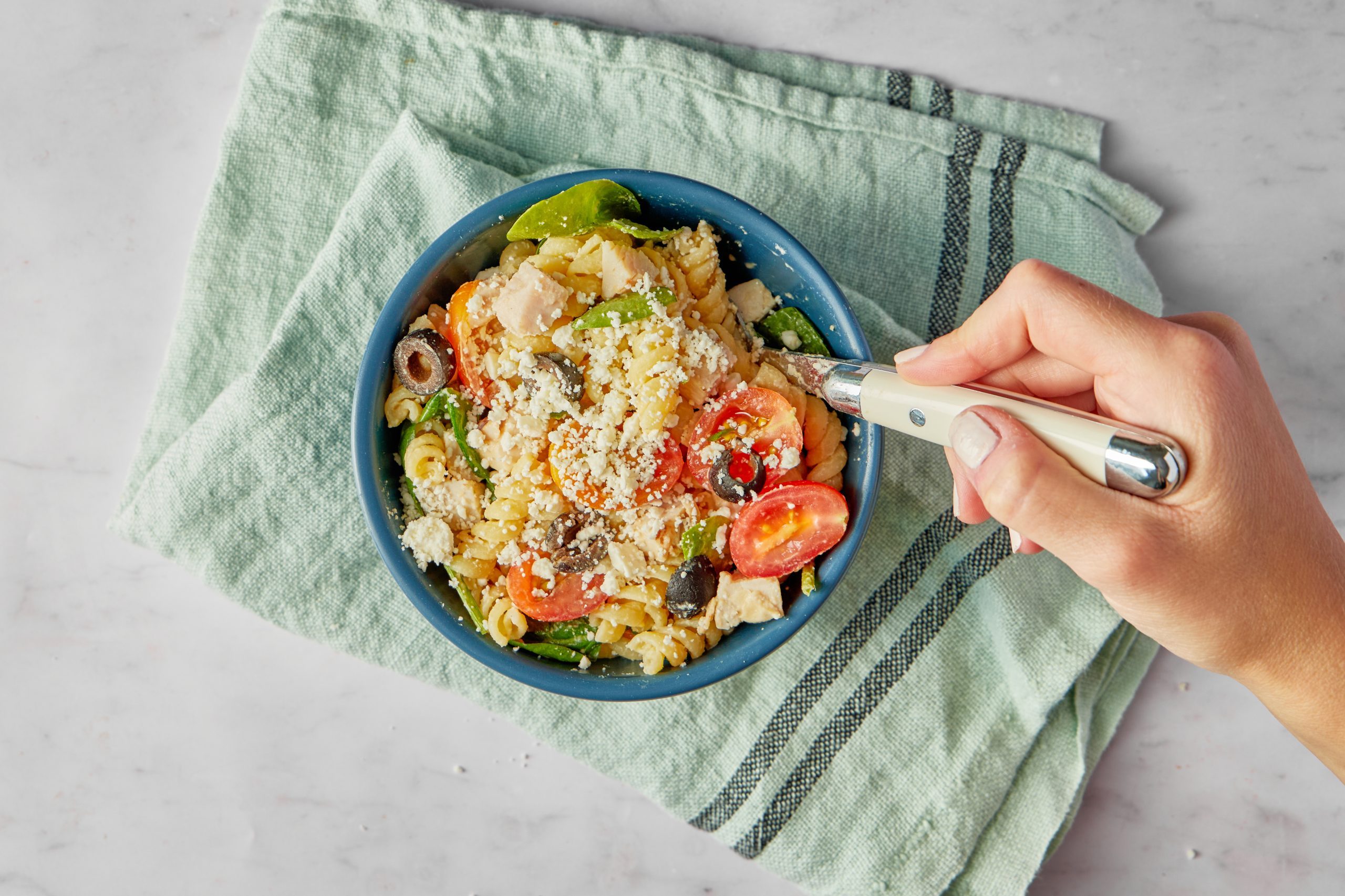 Chicken pasta salad can be a light, healthy lunch in its own right, not just a side dish. This one is especially healthy, thanks to its use of whole wheat pasta and especially its hummus-based dressing.