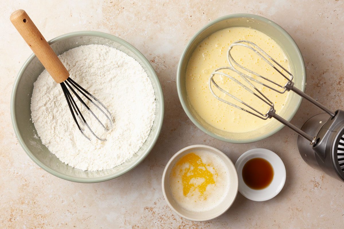 Step 2 of Taste of Home Pineapple Coconut Cake is to combine the flour and baking powder. In another bowl, beat the egg yolks until slightly thickened. Gradually add 1 cup of sugar, beating it with a hand mixer at high speed until thick and lemon-colored. Beat in the melted butter, coconut extract, vanilla extract, and 1/2 cup of the reserved pineapple juice. Add the dry ingredients to the wet mixture and beat until well blended.