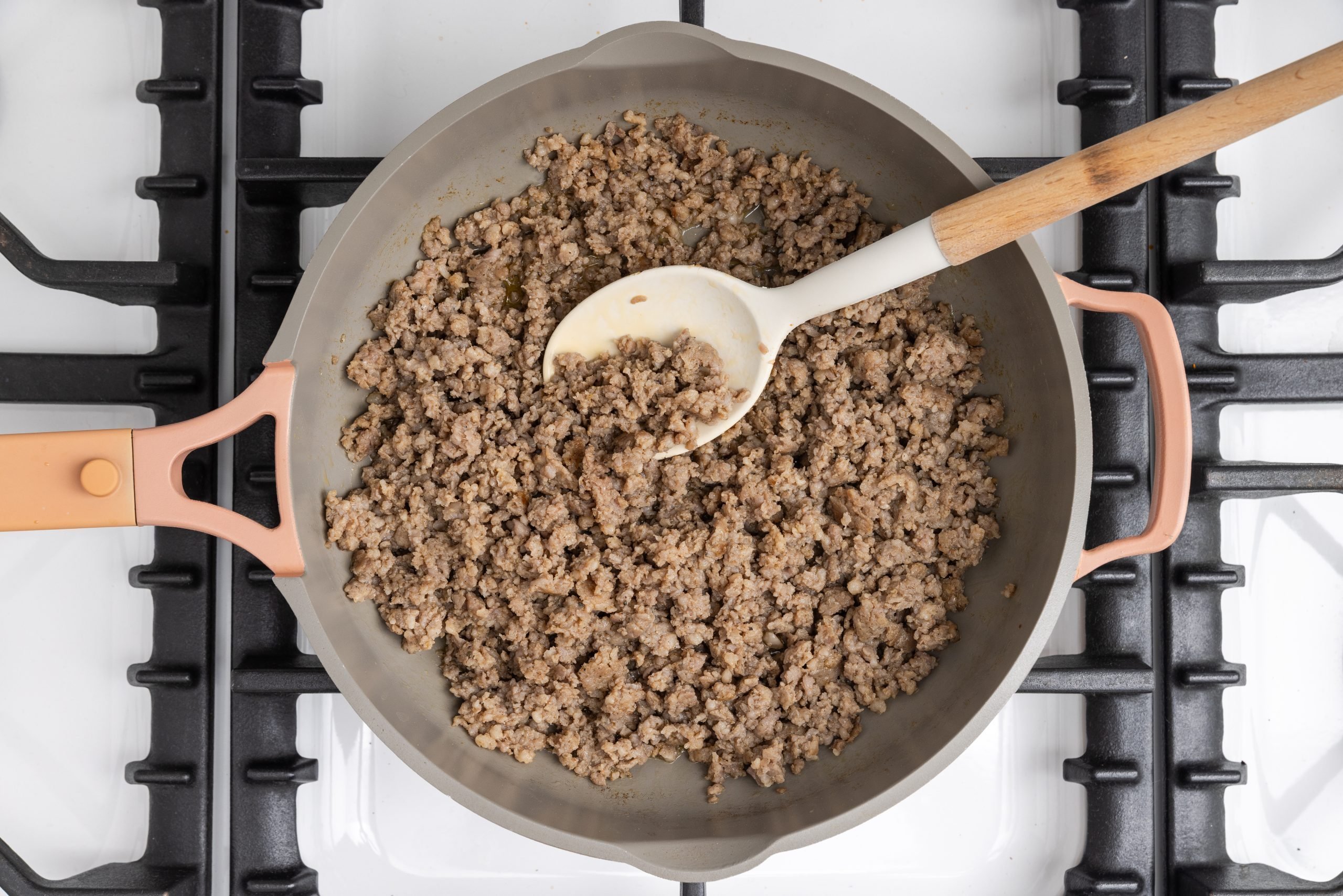 Pork sausage being cooked in skillet.