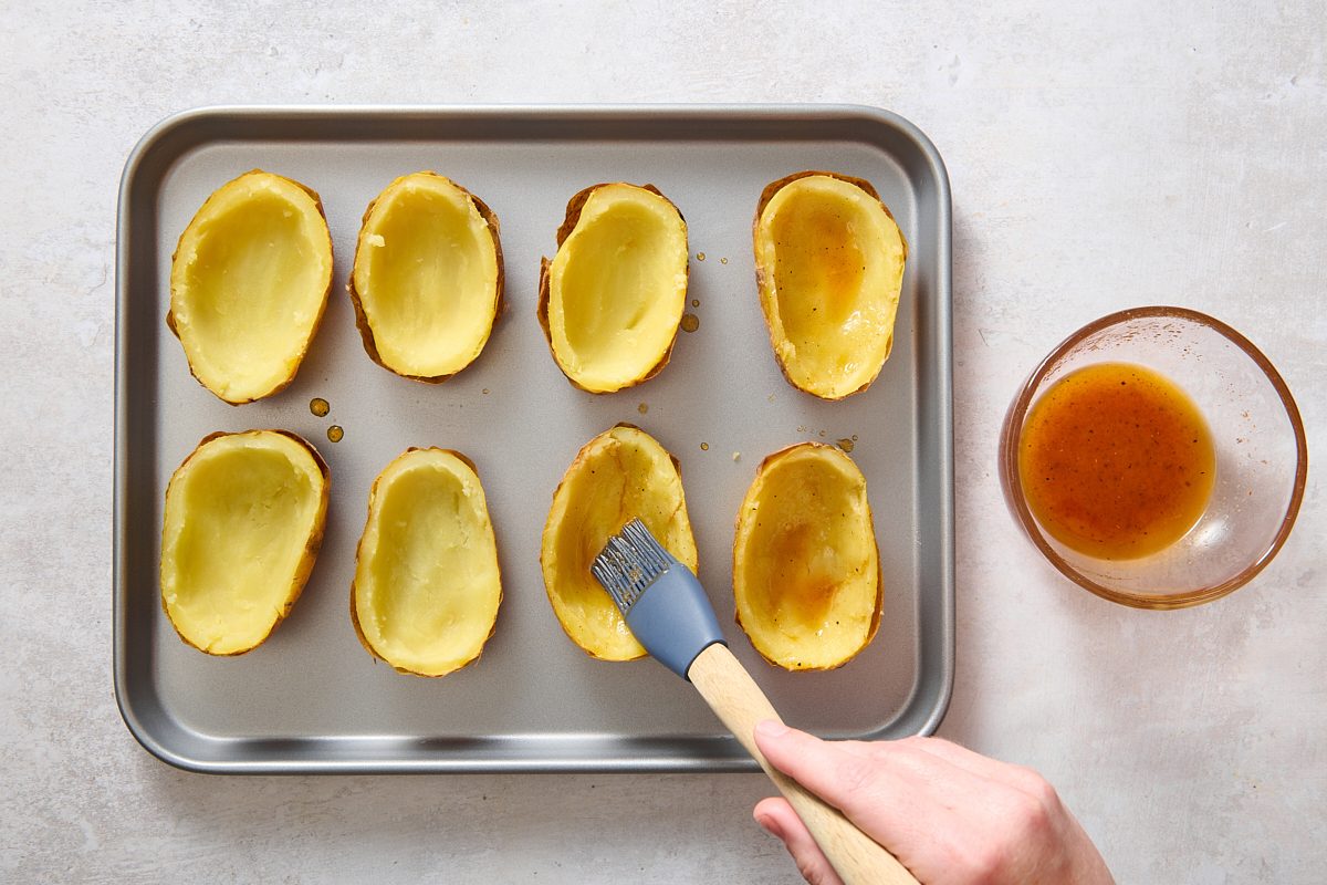 Brushing the oil blend on the potato skins