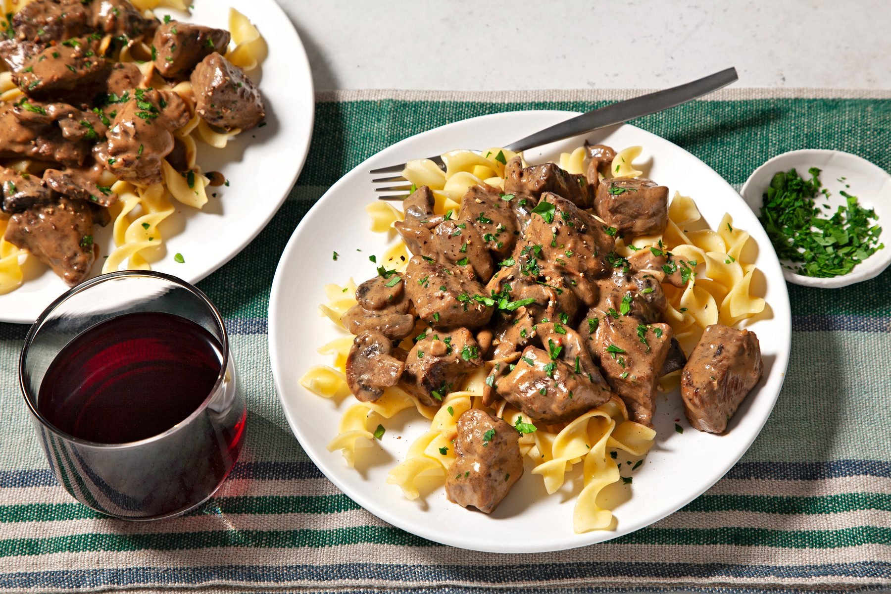 wide shot of dijon sirloin tips served with pasta