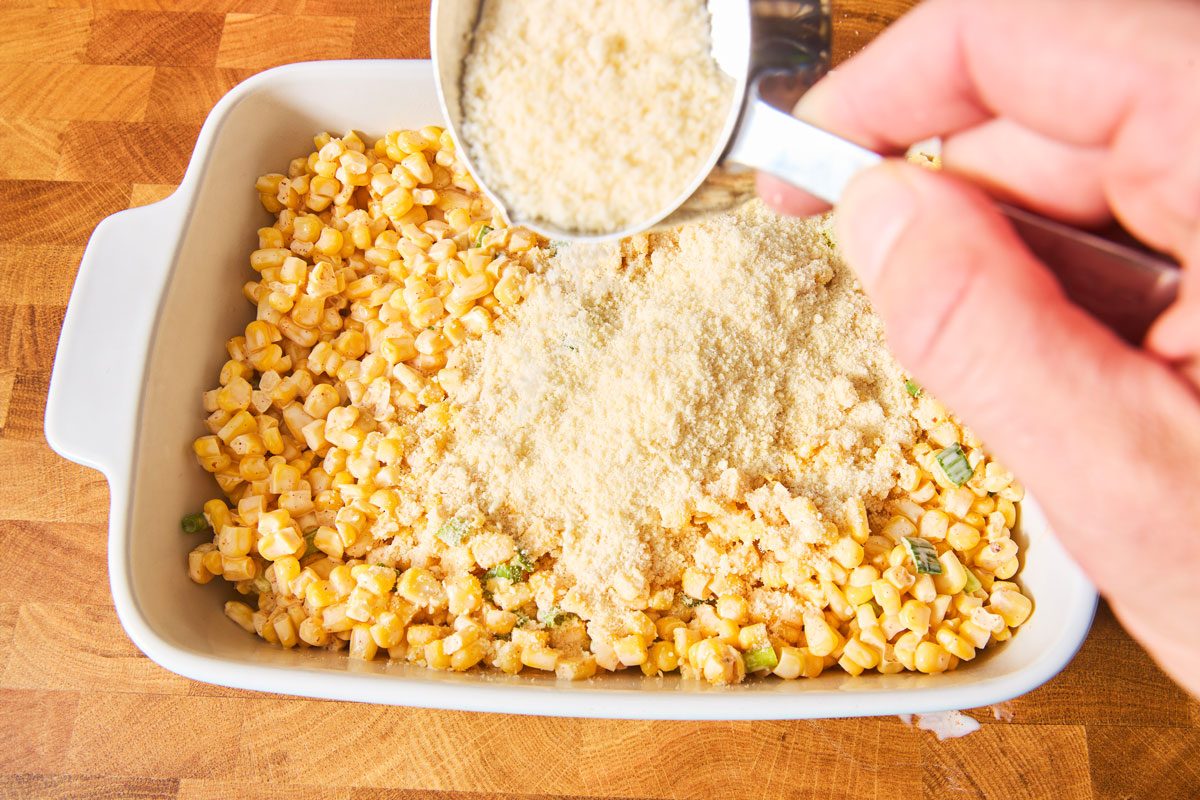 adding cheese to Mexican Street Corn Bake