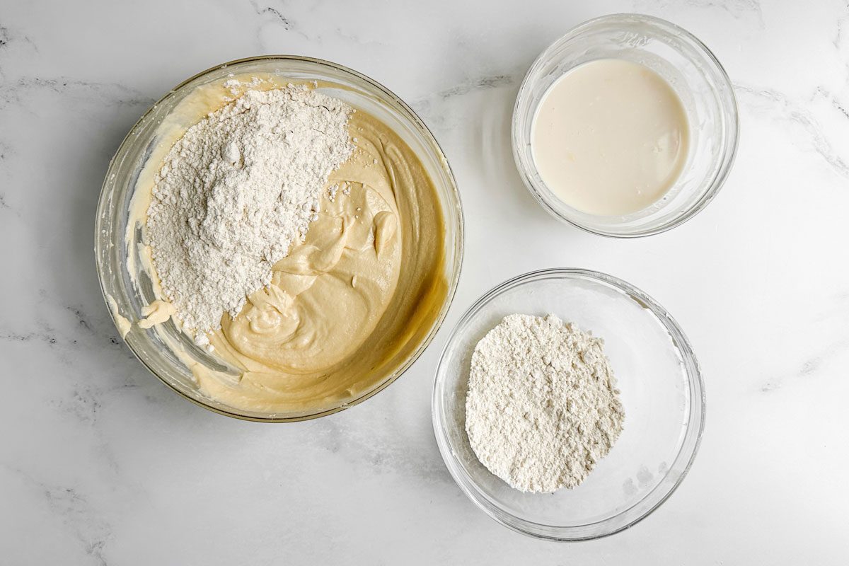 Ingredients for Taste of Home Amaretto Cake in glass bowls on a marble surface