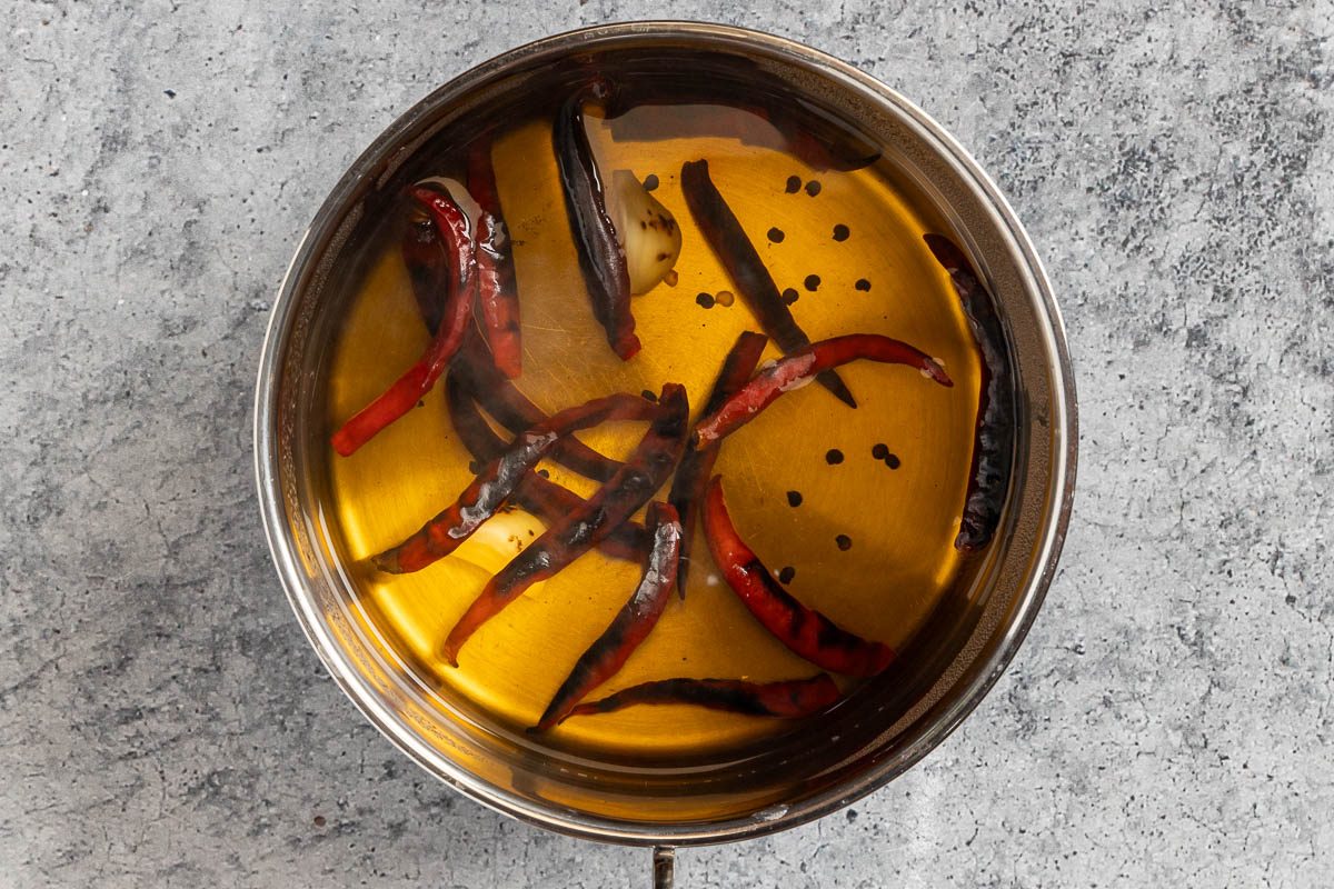 Taste of Home Arbol Chile Salsa photo of the cooked chiles and garlic soaking in hot water.