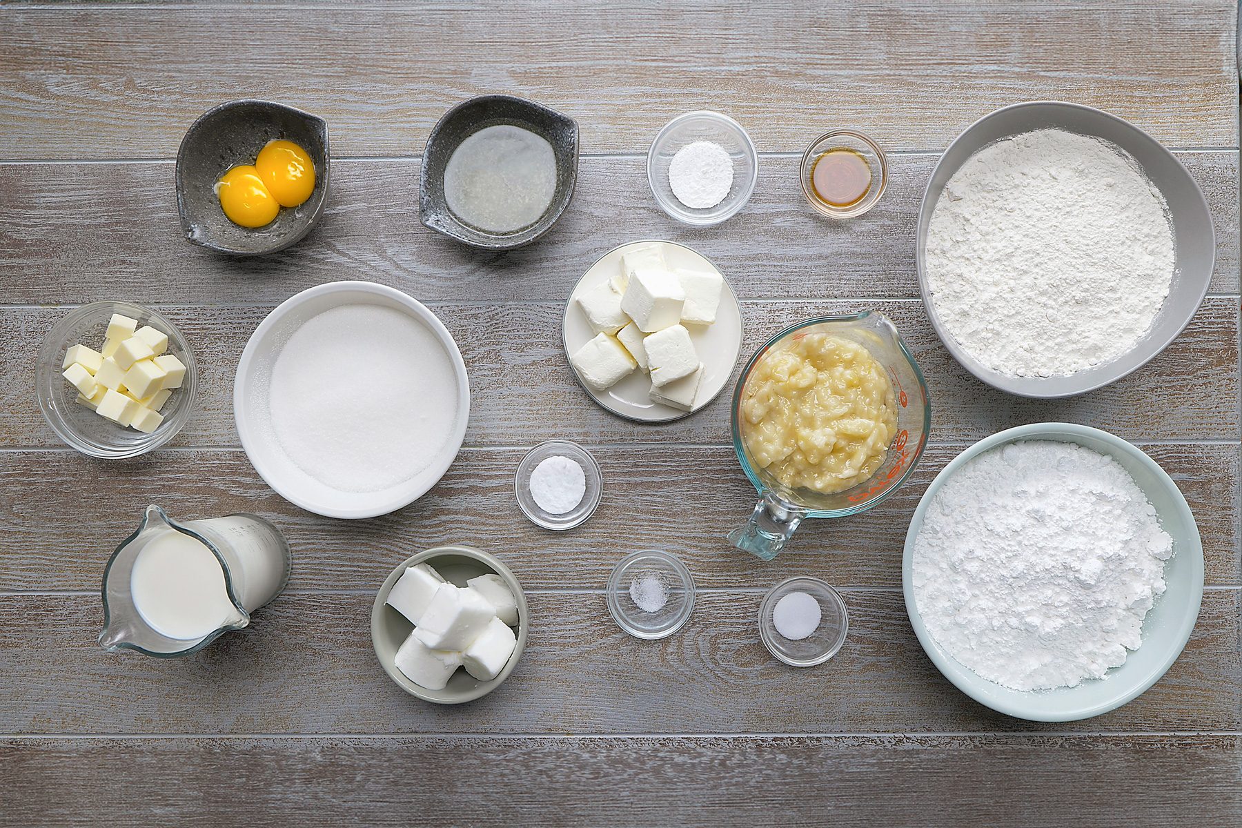 overhead shot of banana cake ingredients placed over grey background