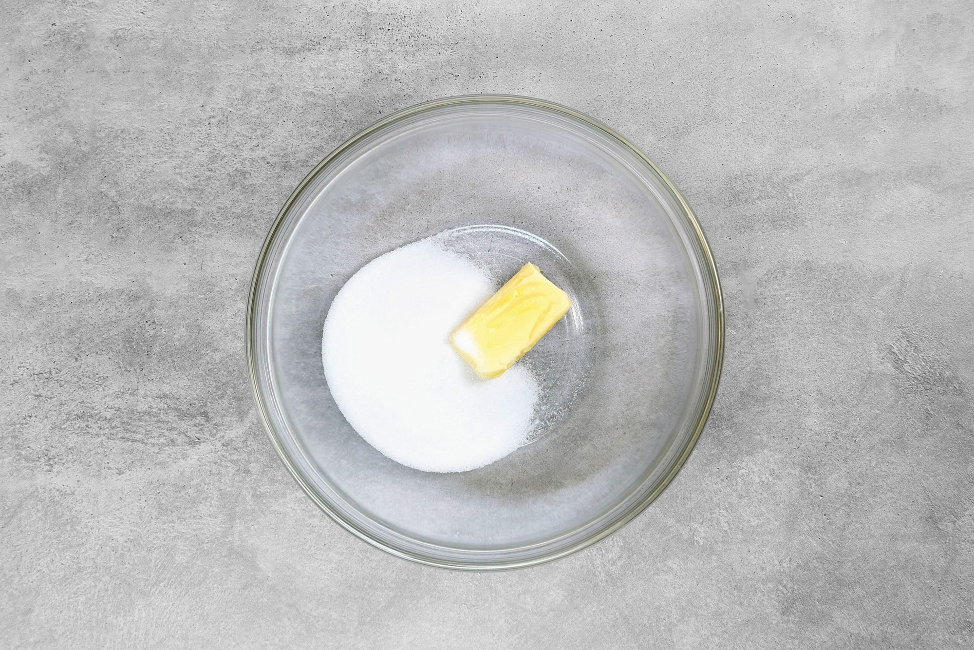 overhead shot; grey background; In a small bowl, cream butter and sugar;
