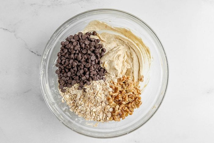 Ingredients for Taste of Home banana oatmeal cookies in a glass bowl on a marble surface