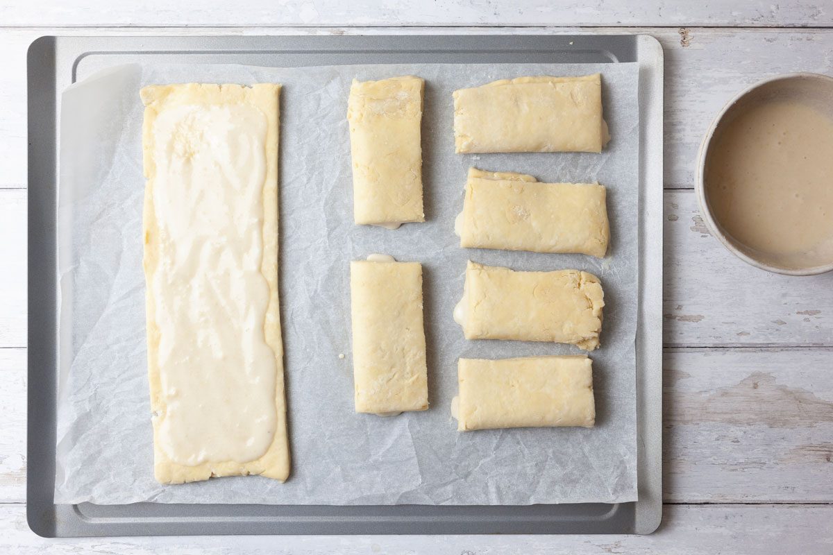 Step 4 of Taste of Home Bear Claw is to beat the egg white until foamy. Gradually add the confectioners' sugar and almond paste; beat until smooth. Cut the dough in half widthwise. Roll each portion into a 12-inch square; cut each square into three 12x4-inch strips. Spread about two tablespoons of filling down the center of each strip. Fold the dough over the filling starting with a long side and pinch the seam to seal. Cut it into three pieces.
