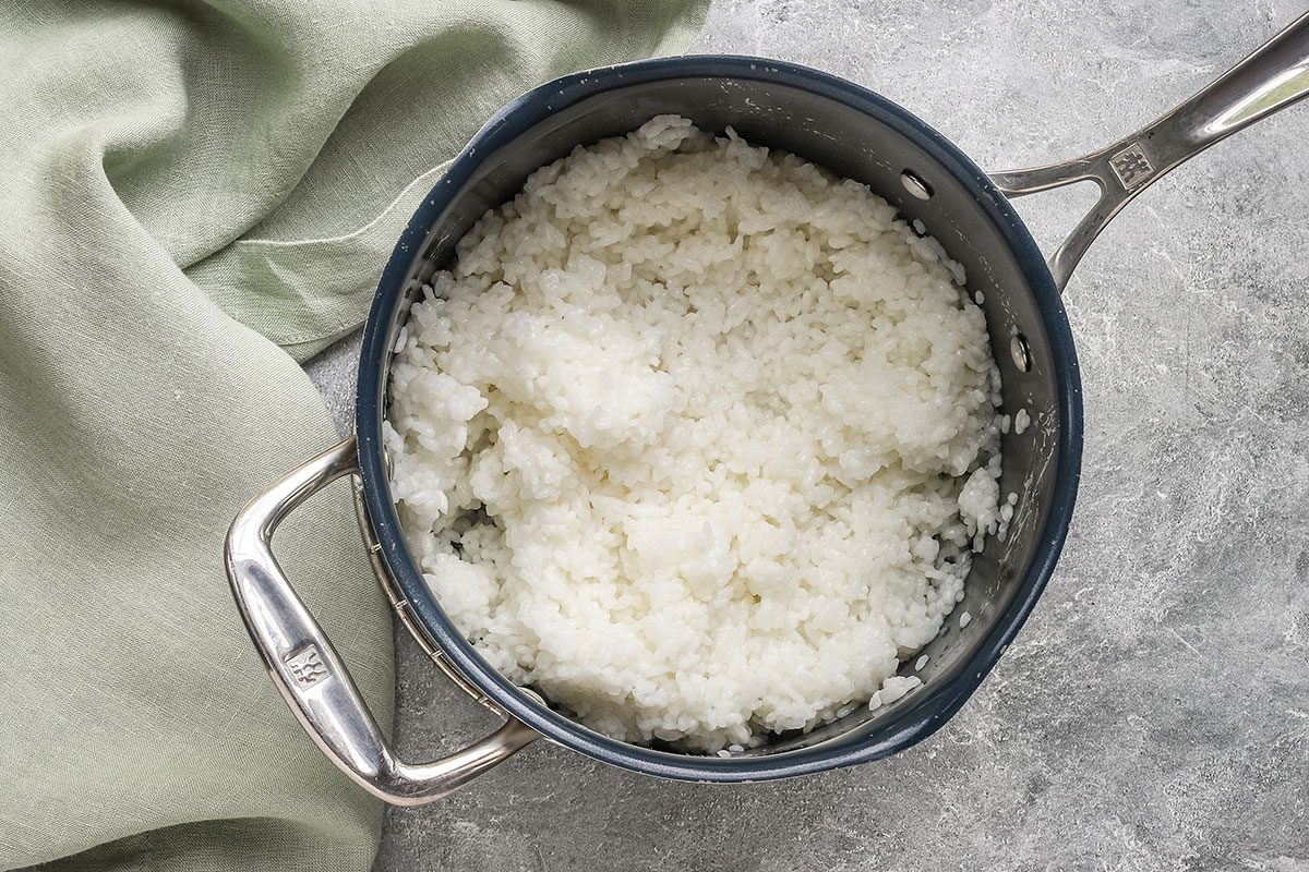 Cooked sushi rice in a saucepan.