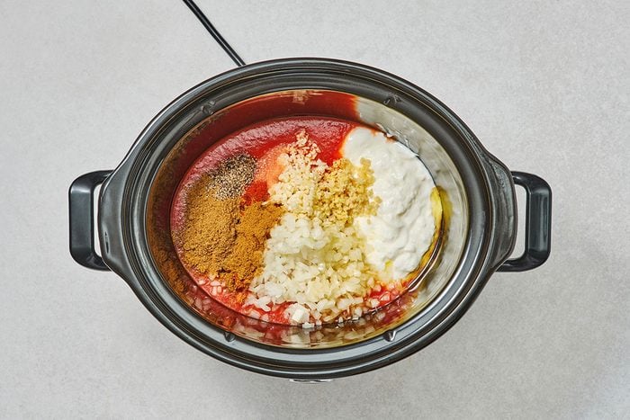 Sauce ingredients in a slow cooker before being mixed