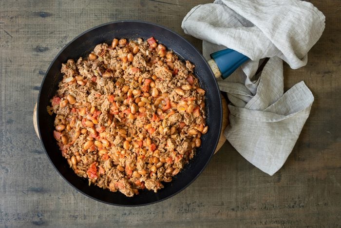 Cooking Onions; Beef; Beans and Tomatoes together in a skillet