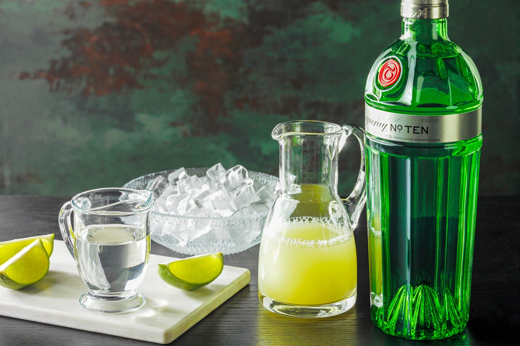 High angle shot of all ingredients; chopping board; green and brown texture wall; black wooden base