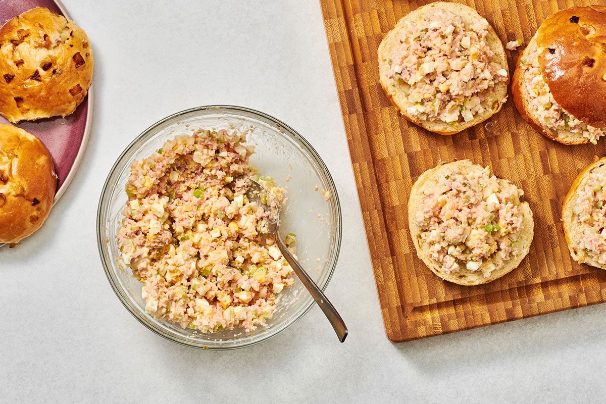 Mixture being spread over each roll bottom then the tops are replaced