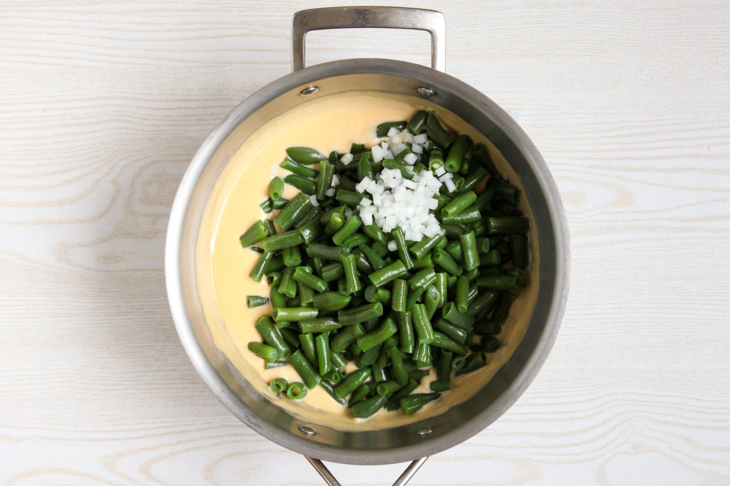 Adding green beans and onion to casserole base