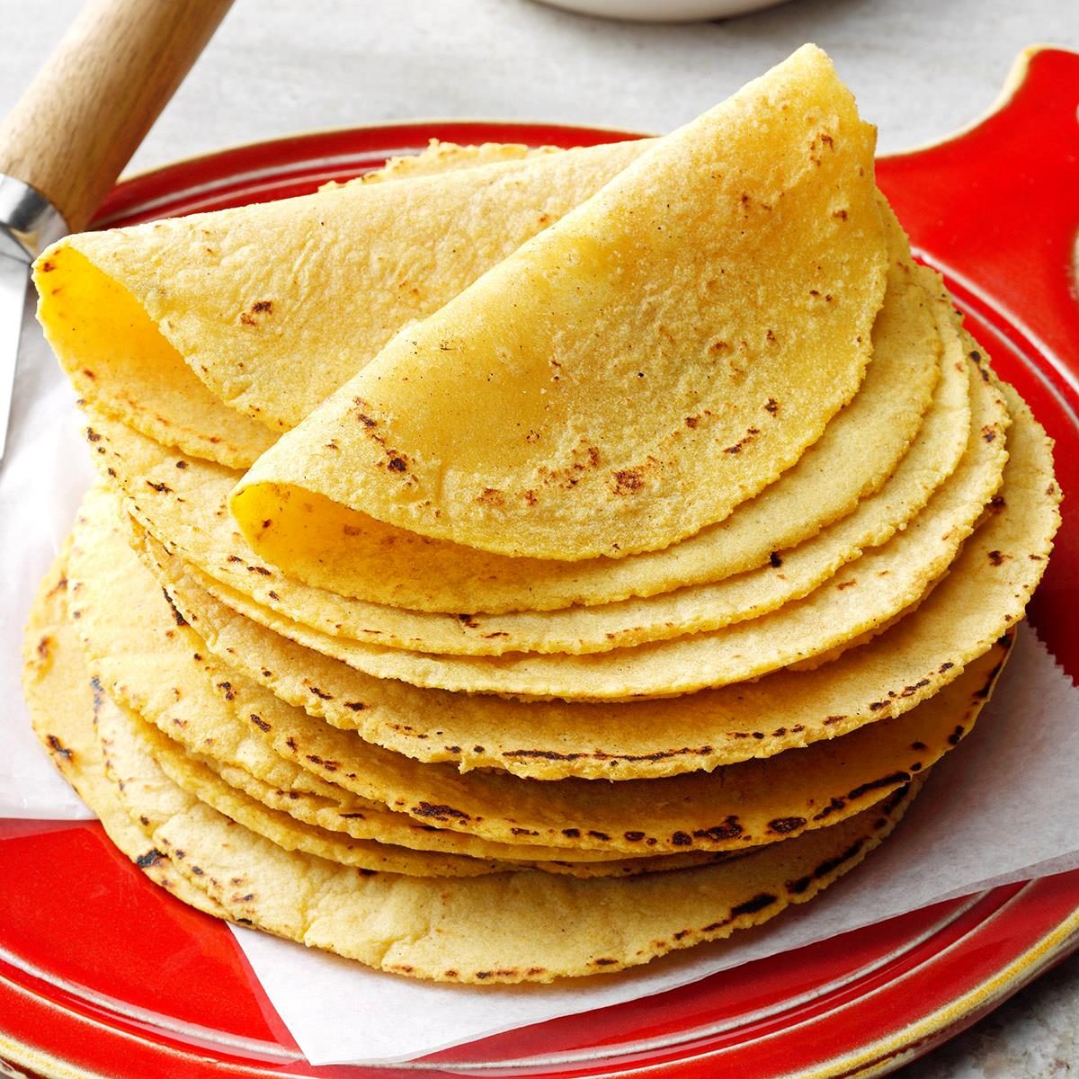 A stack of corn tortillas on a plate by Taste of Home
