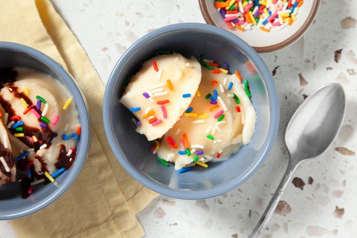 3/4th shot of vanilla ice cream in a bag topped with sprinkler and syrup