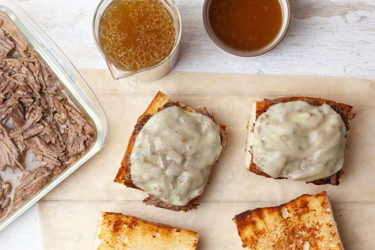 Step 4 of Taste of Home Instant Pot French Dip is to slice the French bread lengthwise and pile the warm beef onto the bottom half. If desired, top with sliced provolone or Swiss cheese. Serve with a side of the strained au jus for dipping.