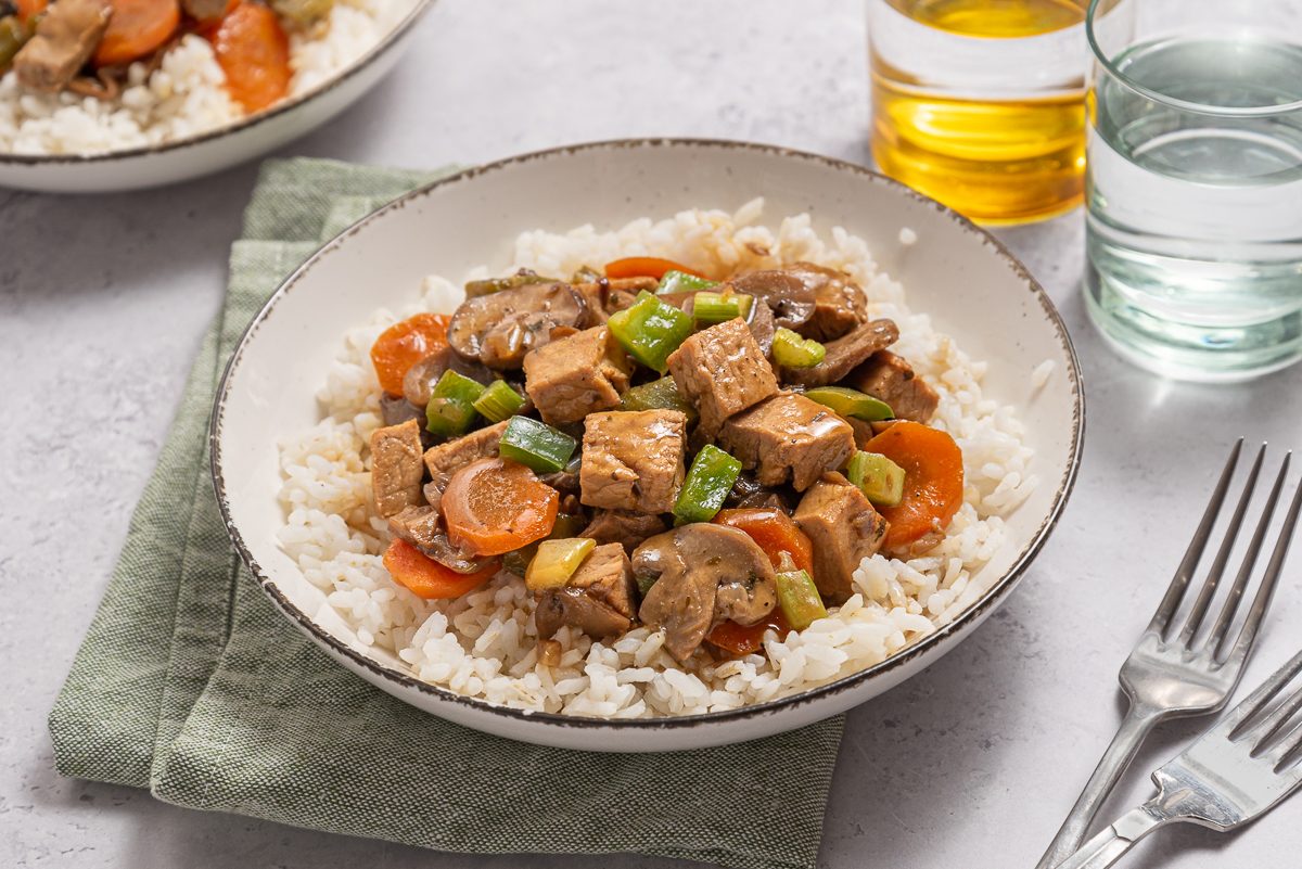 Closeup Of Plate With Rice, Vegetables And Leftover Pork