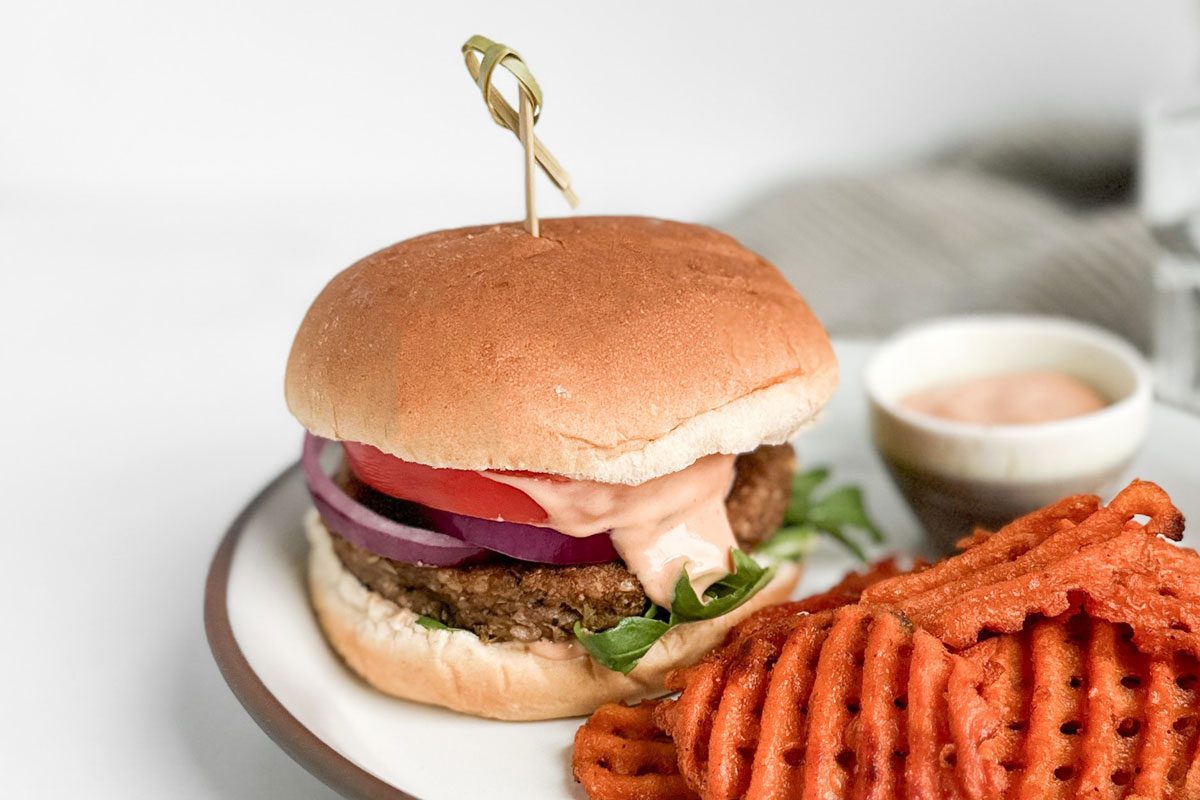 Ingredients for Taste of Home Lentil Burger on a ceramic plate with waffle fries