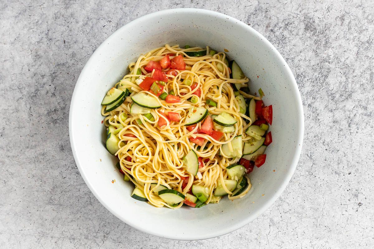 Taste of Home Linguine Salad recipe photo of the linguine added to the mixing bowl and all ingredients tossed with the Italian dressing.
