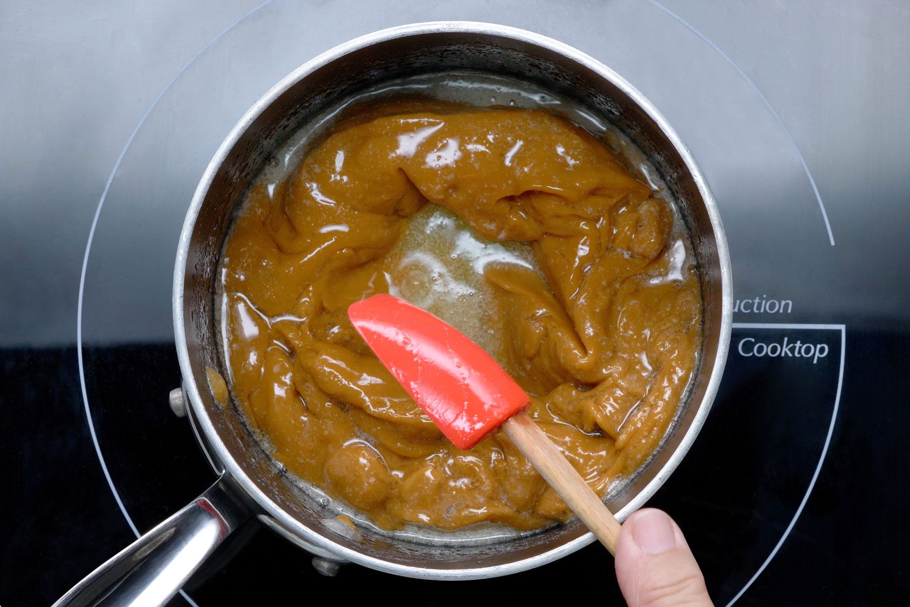 Melted caramel candies in a saucepan.