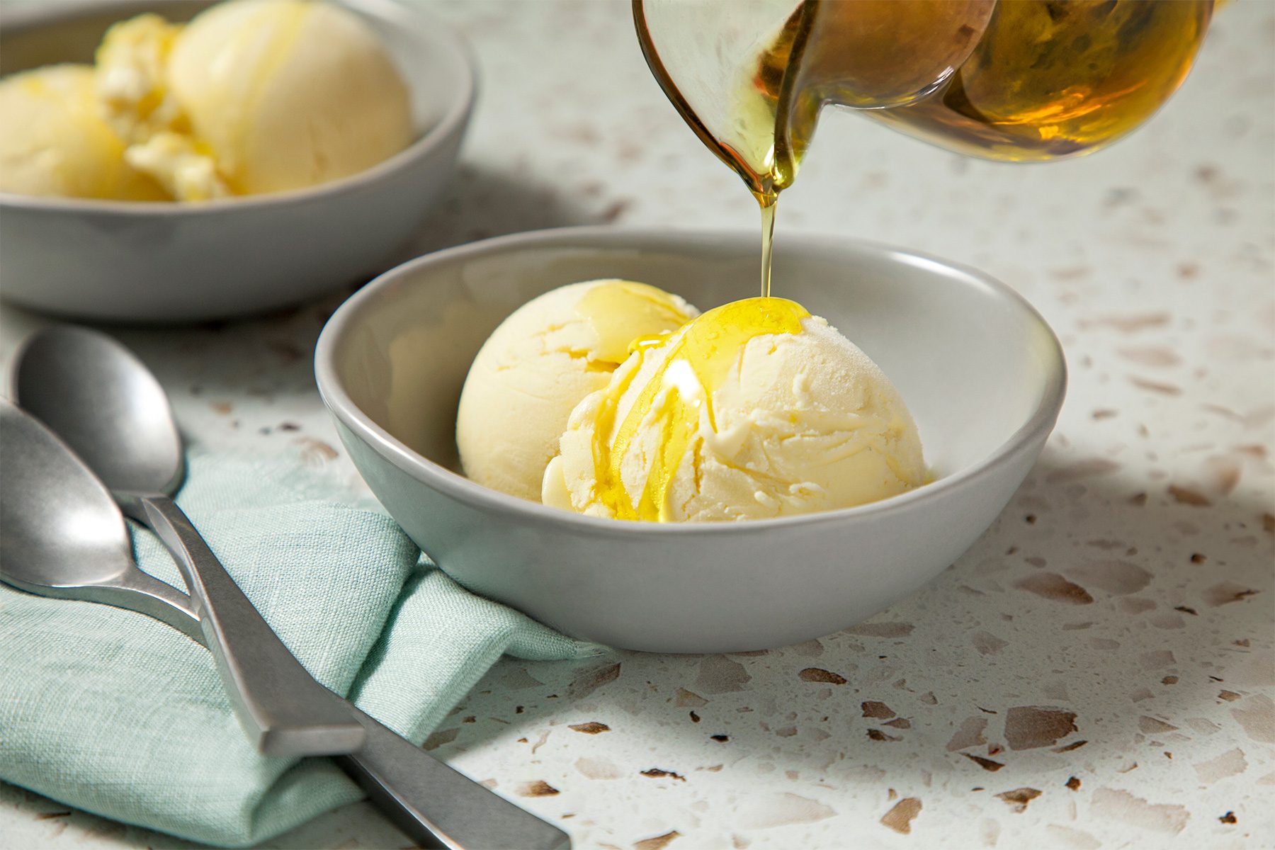 3/4th shot of olive oil ice cream drizzled with olive oil