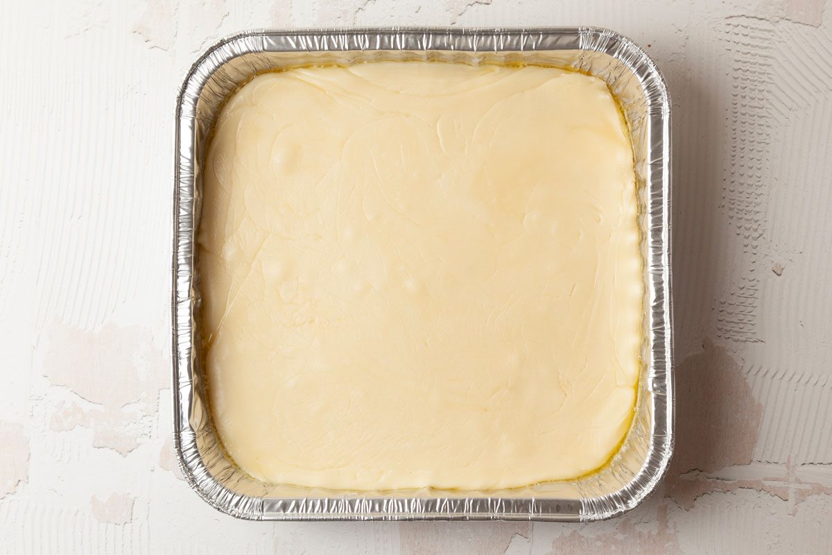 Step 3 of Taste of Home Pecan Logs is to remove the sugar mixture from the heat and stir in the vanilla. Continue stirring as it cools and thickens. The mixture should mound slightly when you drop it from a spoon. Spread the mixture into the buttered pan and let it cool.