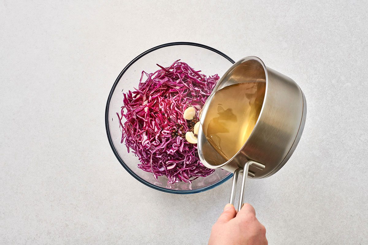 Pouring hot brine over the cabbage