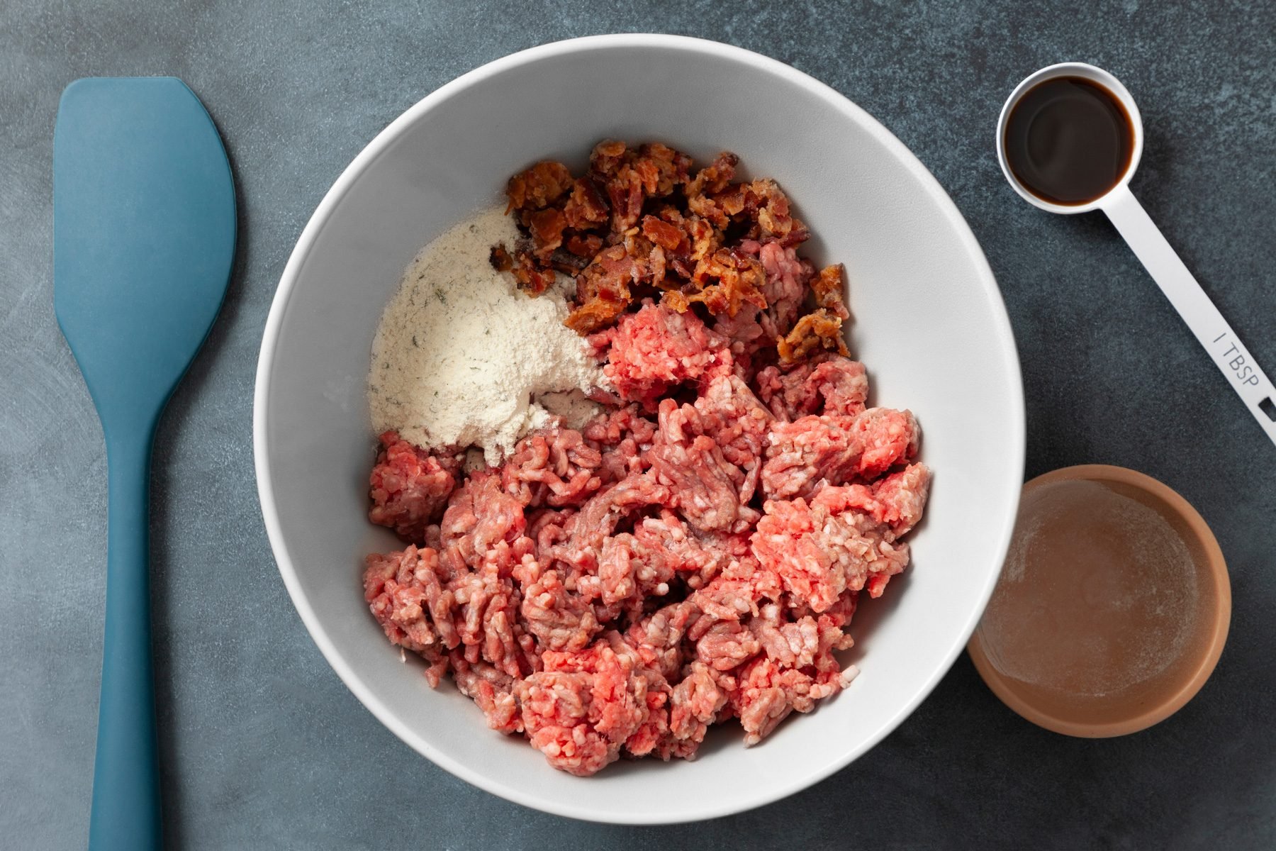 In a large bowl, combine ground beef, ranch mix, bacon and Worcestershire; mix lightly but thoroughly