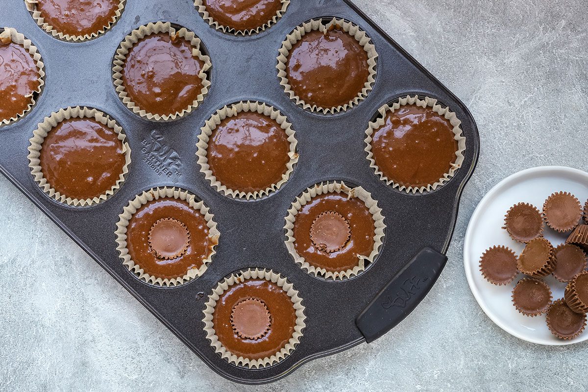 Peanut butter cup cupcakes ready to bake, made with miniature Reese's peanut butter cups and a chocolate cake mix.