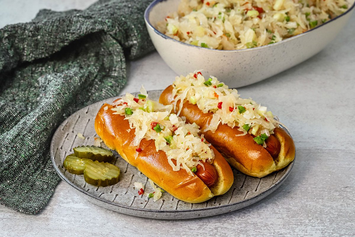 Sauerkraut salad shown on hot dogs.
