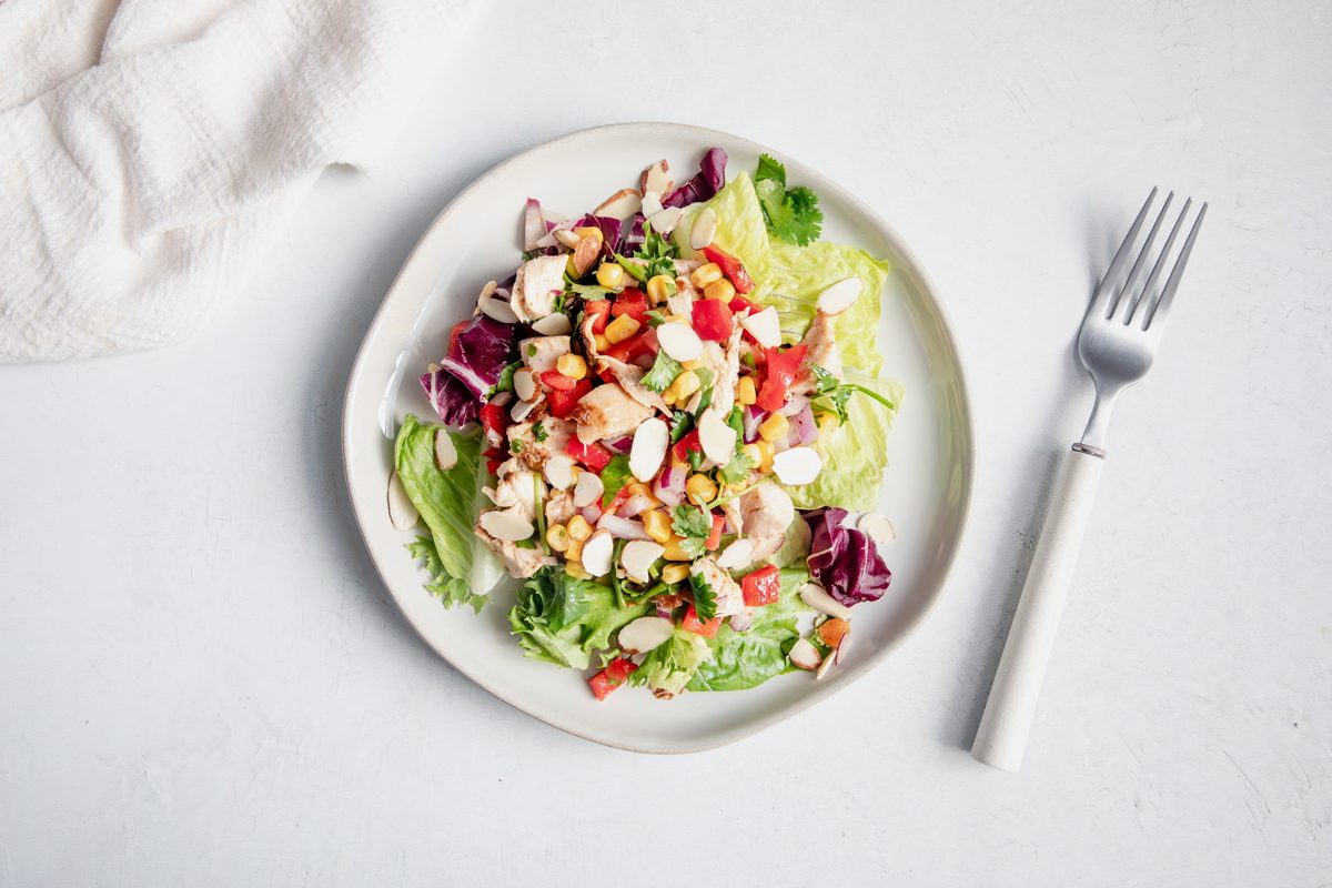 Overhead shot for Taste of Home Southwest Chicken Salad on top of a bed of lettuce.
