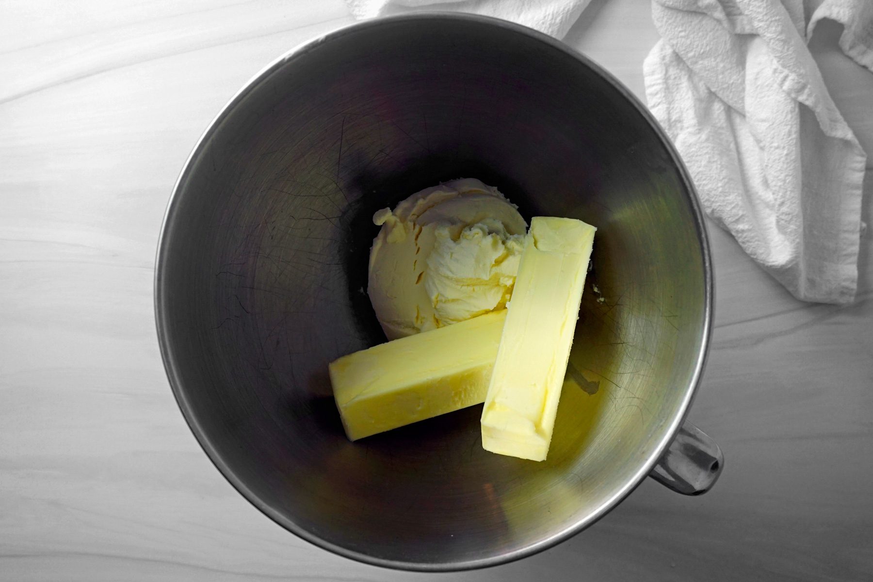 Adding butter and mascarpone in a bowl