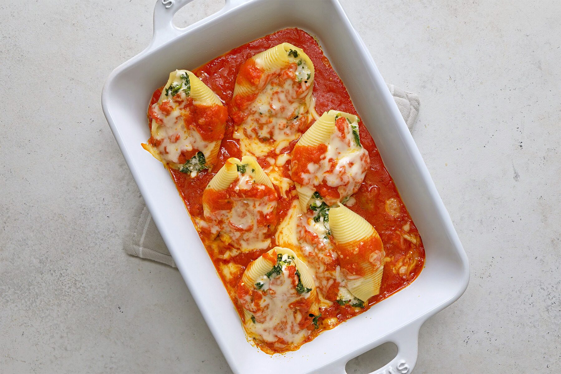 overhead shot of stuffed shells in a baking dish