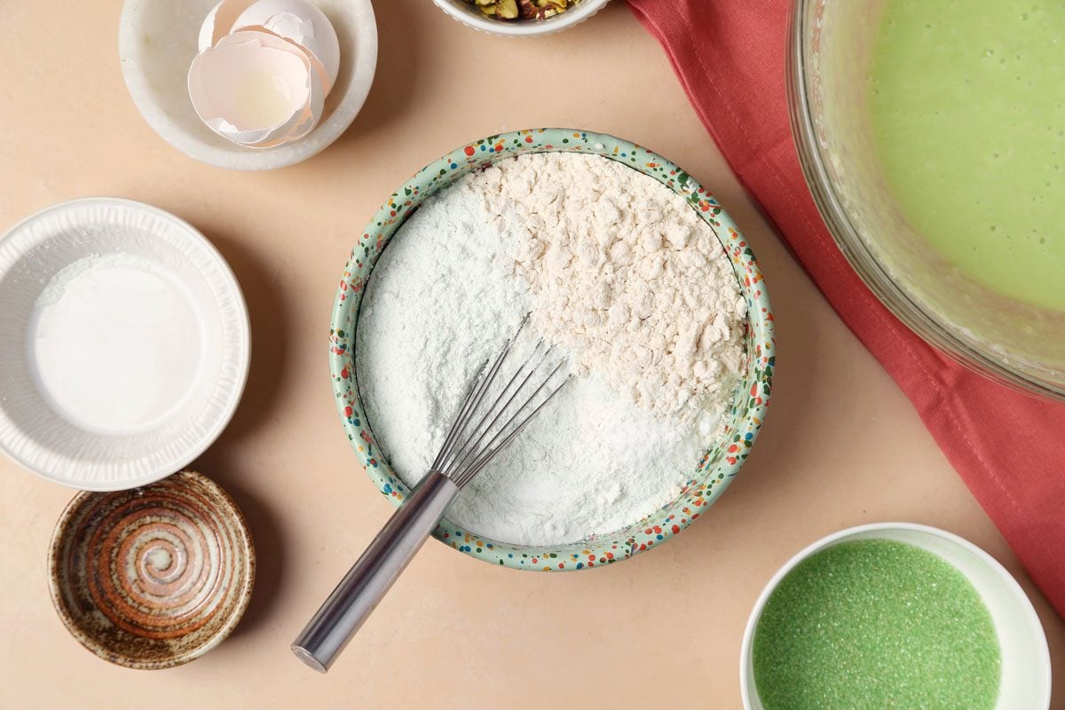 The process of making Taste of Home's Pistachio Cookies. Mixing of dry ingredients in a bowl.