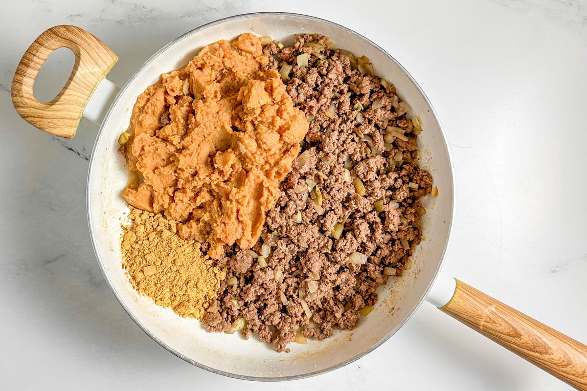 Ingredients for Taste of Home Taco Cups in a white skillet