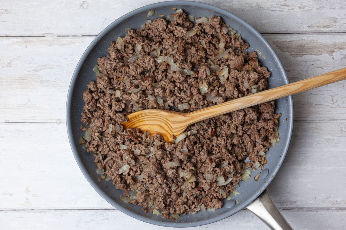 Step 1 of Taste of Home Taco Pie is to preheat the oven to 400°F. In a large skillet, brown the ground beef and onion over medium heat until the meat is no longer pink, breaking the beef into crumbles as it cooks. Drain any excess fat.