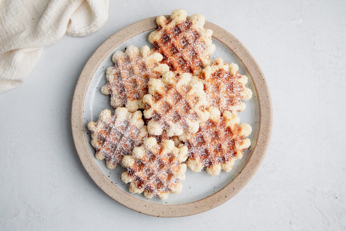 Overhead beauty shot for Taste of Home Waffle Cookies on a plate on a marble surface.