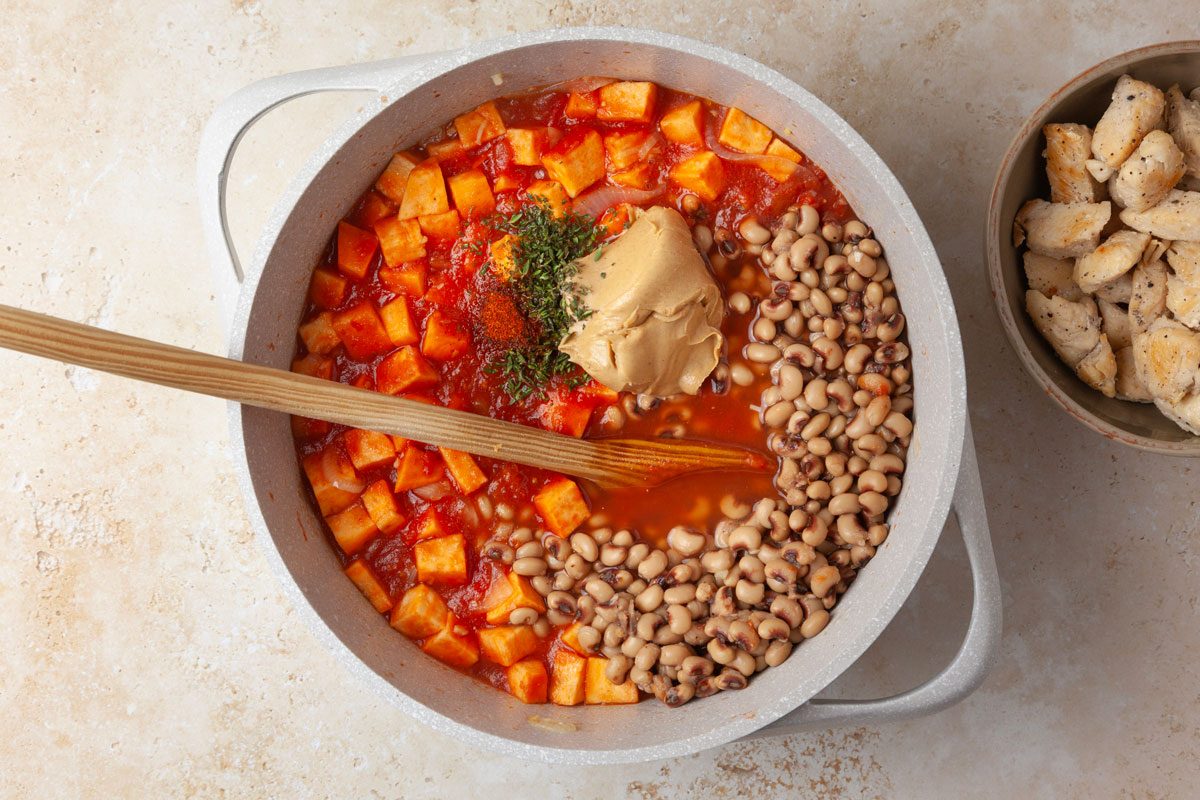 Step 3 of Taste of Home West African Chicken Stew is to stir in the peas, tomatoes, sweet potato, broth, peanut butter, 1-1/4 teaspoons of the thyme and the cayenne pepper. Add the chicken once sweet potato is cooked.