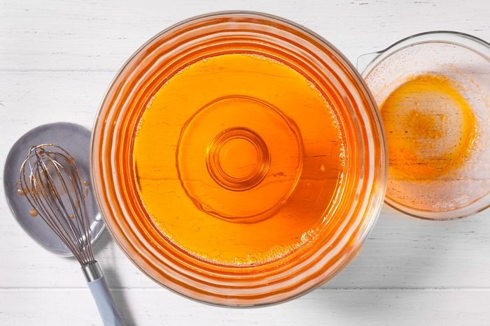 Two glass bowls are filled with a vibrant orange liquid