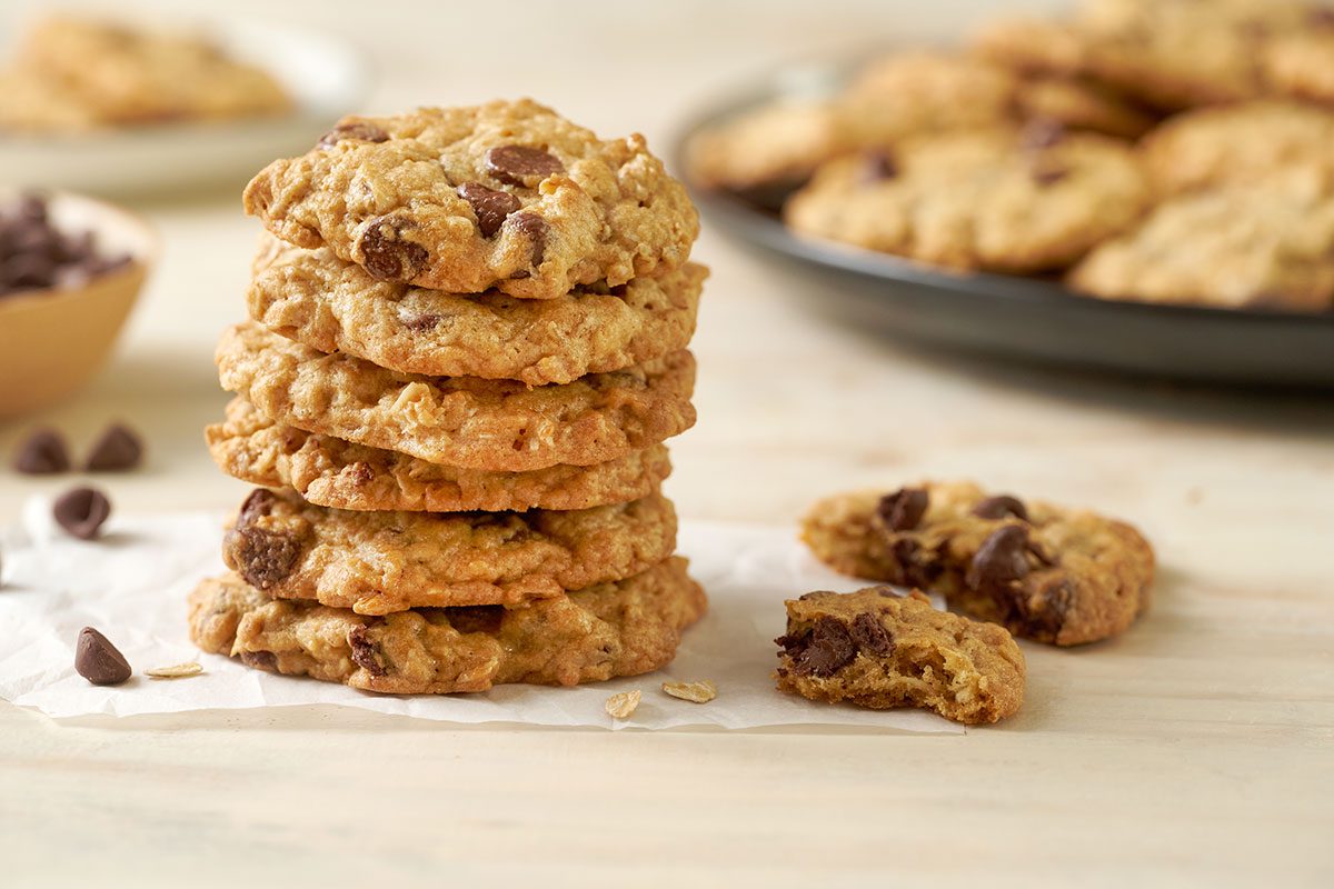 Close-up horizontal shot of the Taste of Home Air Fryer Oatmeal Cookies, Stacked and highlighting the the crispy edges, with melted chocolate chips visible.