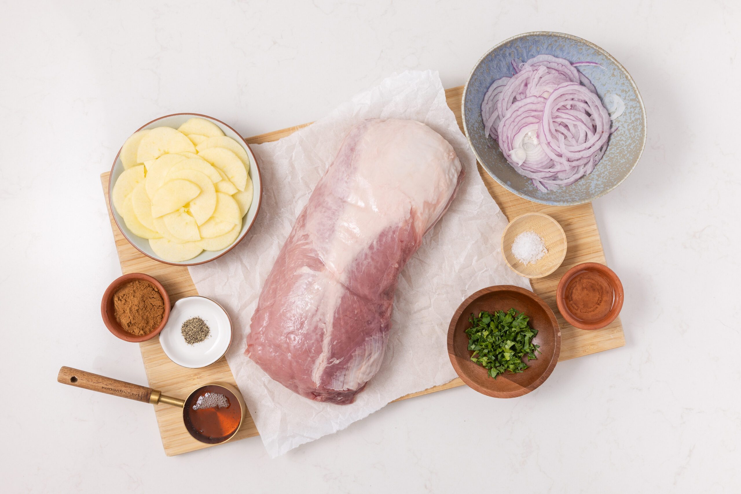 Ingredients for apple pork loin on kitchen counter.