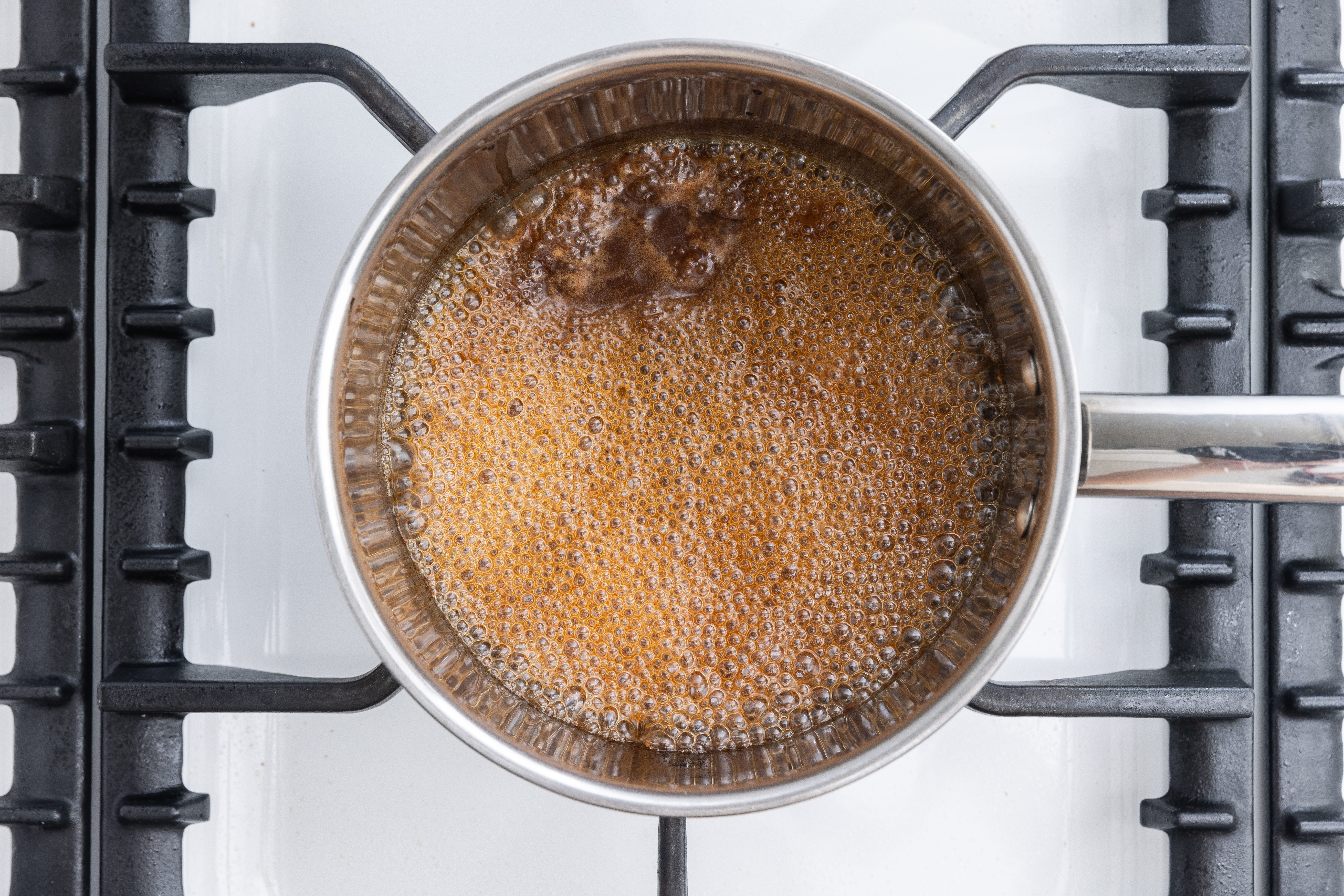 Juices being brought to a boil to make the sauce served with pork loin.