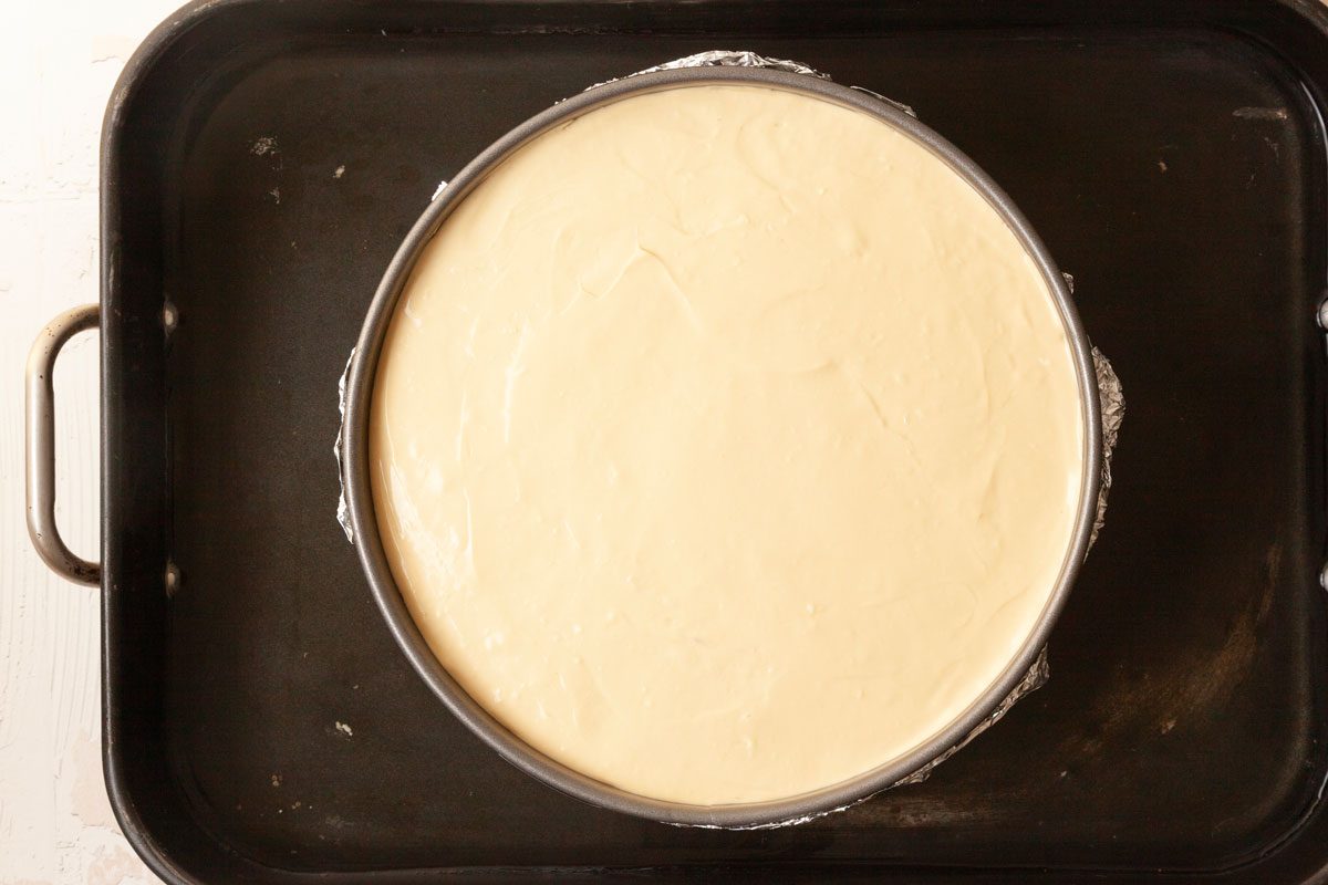 Step 3 of Taste of Home Biscoff Cheesecake is to bake the cheesecake and then top with melted cookie butter