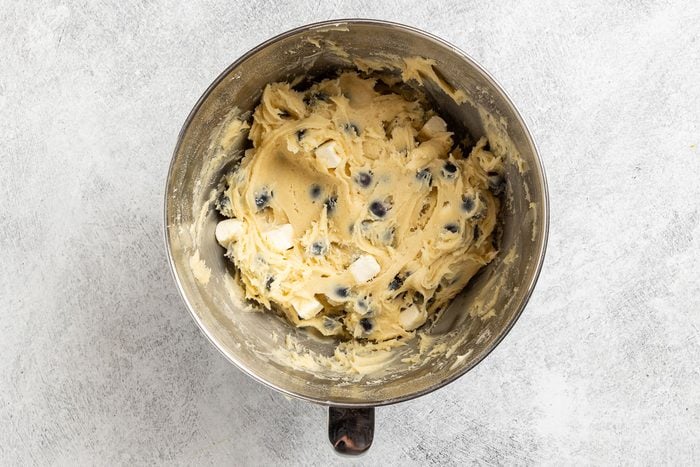 Taste of Home Blueberry Cheese Cake photo of folding in the blueberries and frozen cream cheese cubes.