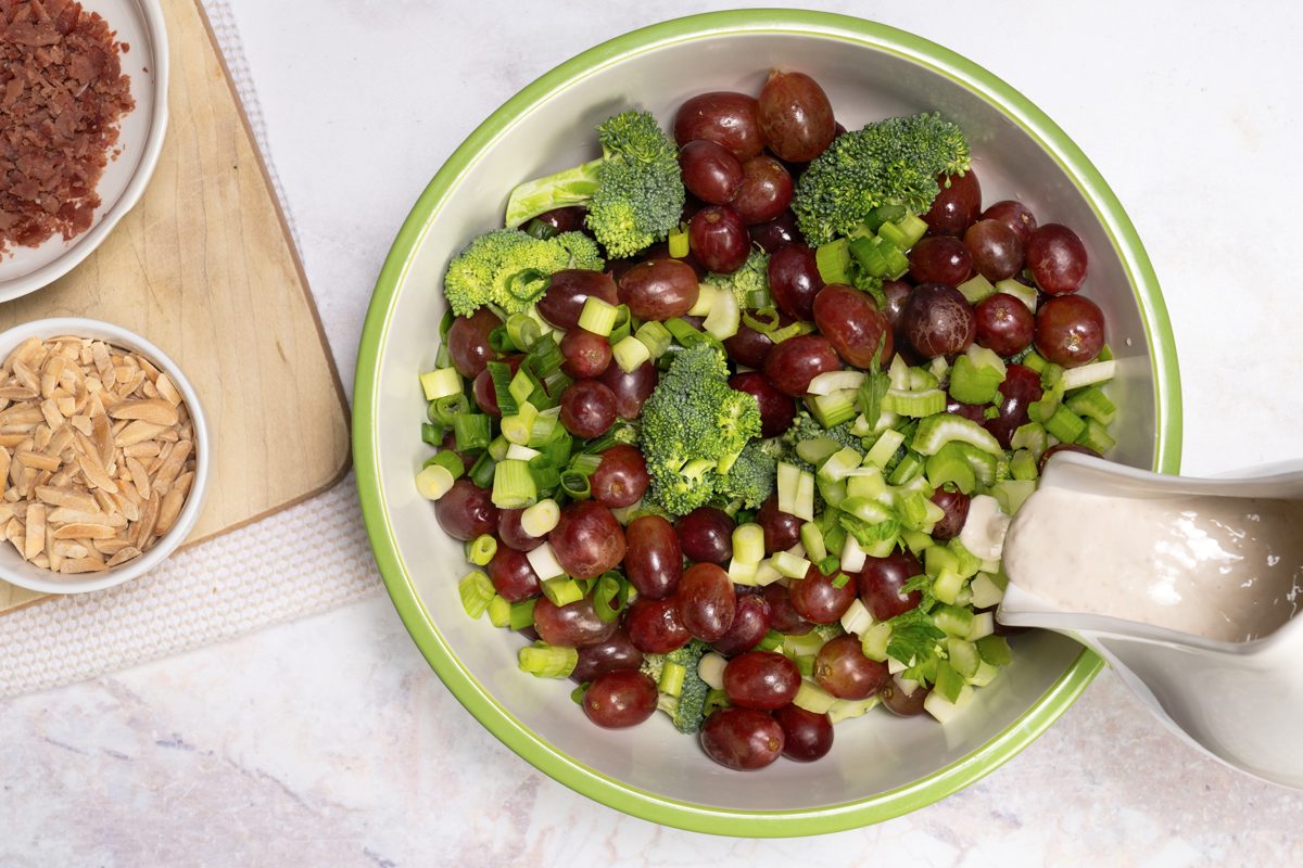 Pouring the dressing Broccoli Grape Salad