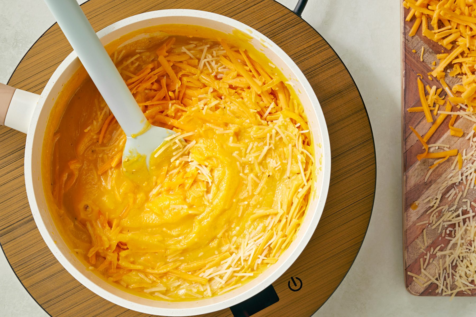 Return mixture to saucepan; heat through; Stir in cheeses until melted