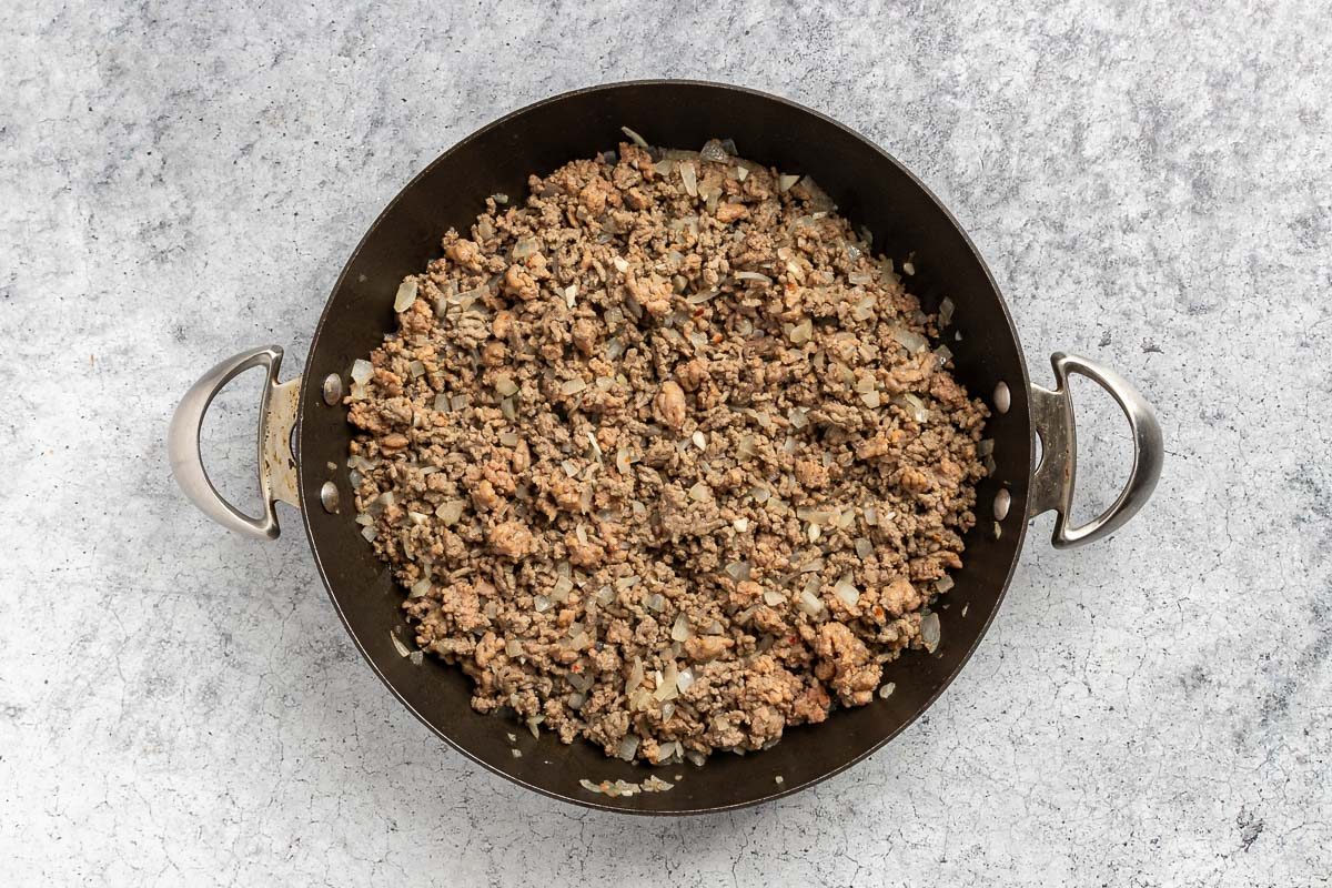 browning the beef and sausage with onion and garlic.